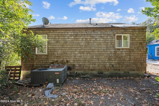 view of side of home with central AC