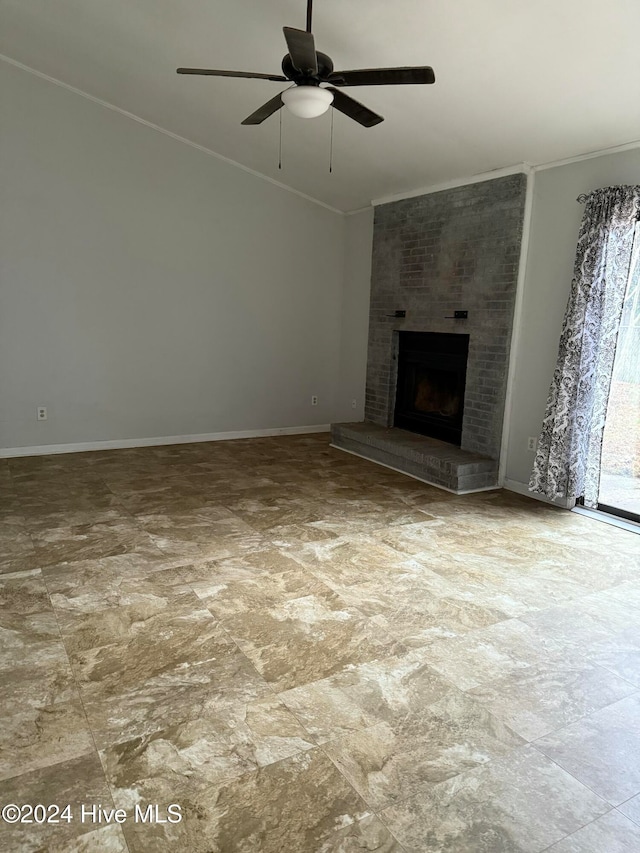 unfurnished living room featuring ceiling fan, crown molding, and a brick fireplace