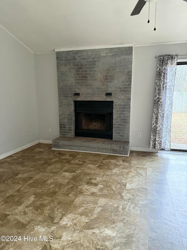 unfurnished living room with a brick fireplace, ceiling fan, and ornamental molding