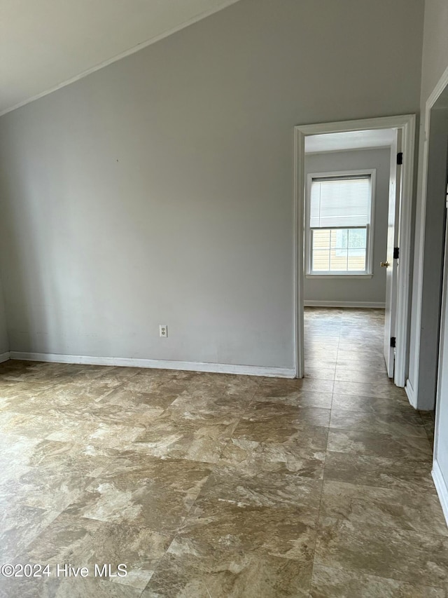 spare room with vaulted ceiling