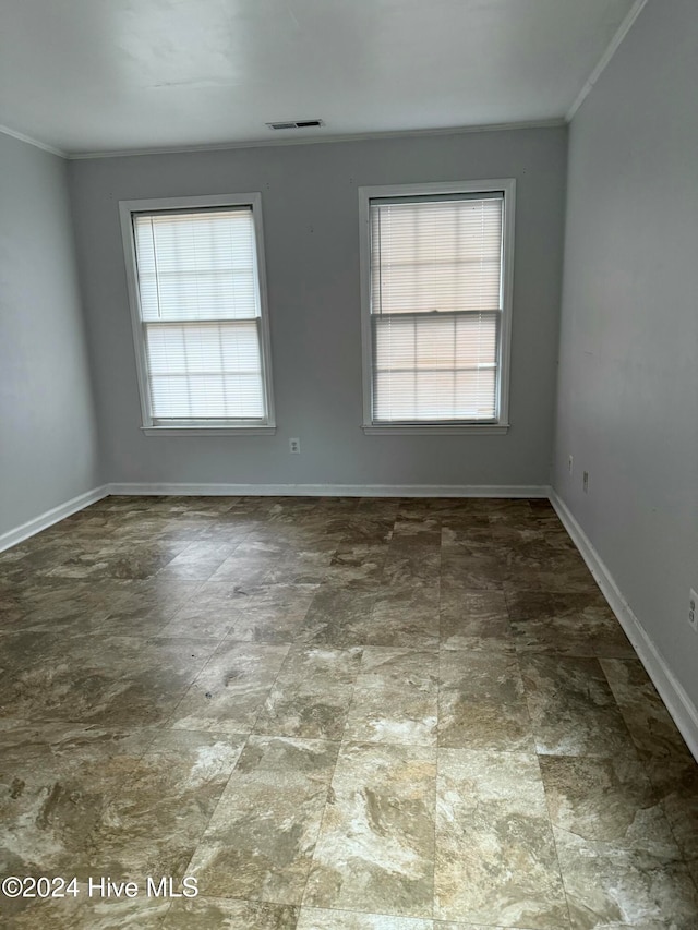 unfurnished room featuring crown molding