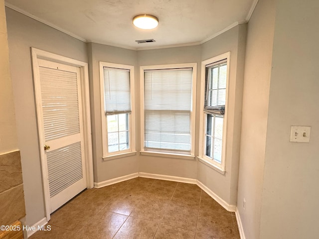 doorway to outside featuring tile patterned flooring and ornamental molding