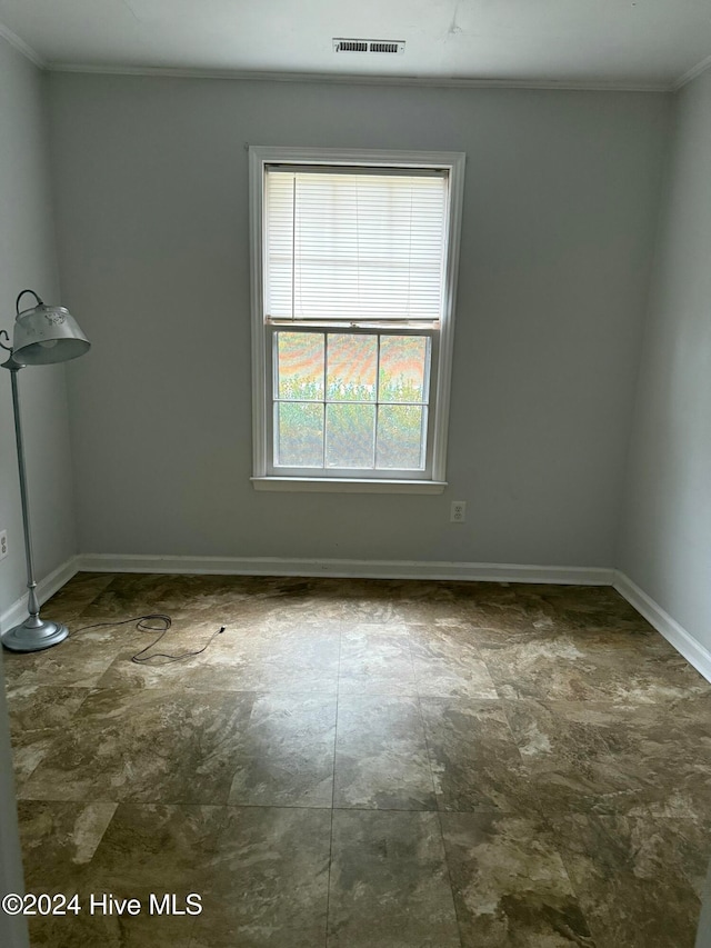 spare room with crown molding