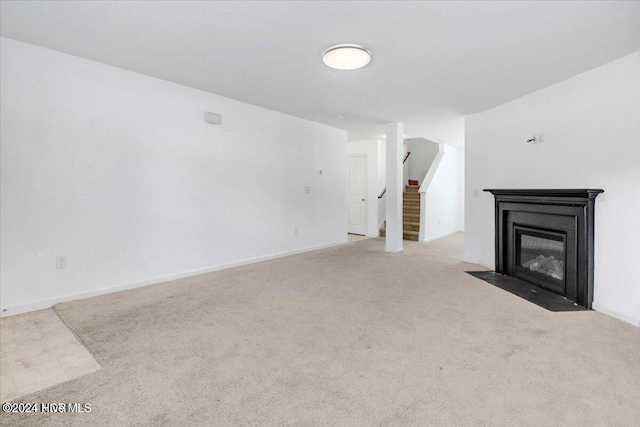 unfurnished living room featuring light carpet