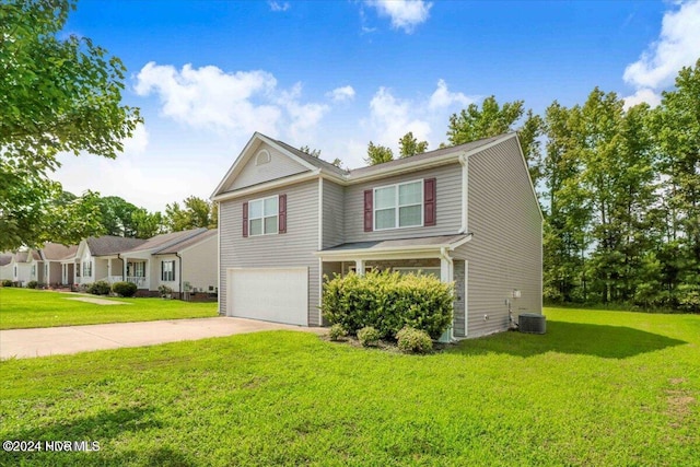 view of property featuring central AC unit, a garage, and a front lawn