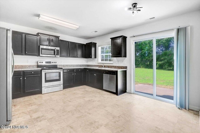 kitchen with sink and appliances with stainless steel finishes