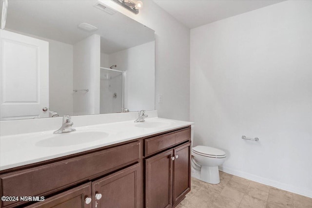 bathroom with vanity, toilet, and a shower with shower door