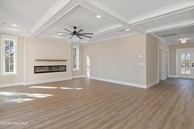 unfurnished living room featuring beamed ceiling, ceiling fan, crown molding, and hardwood / wood-style floors