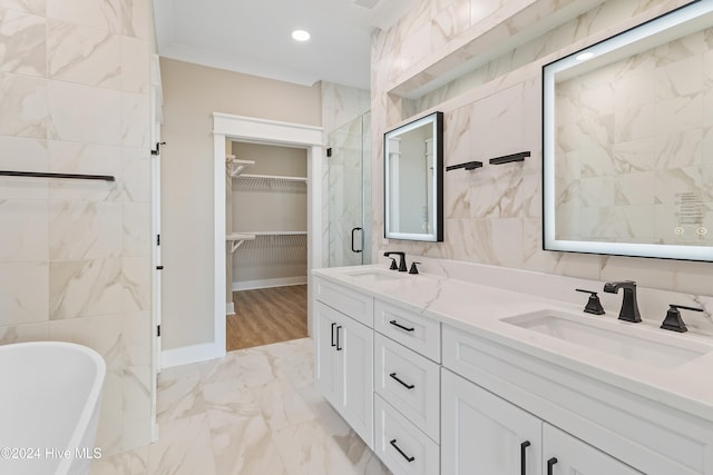 bathroom featuring vanity, ornamental molding, tile walls, and independent shower and bath