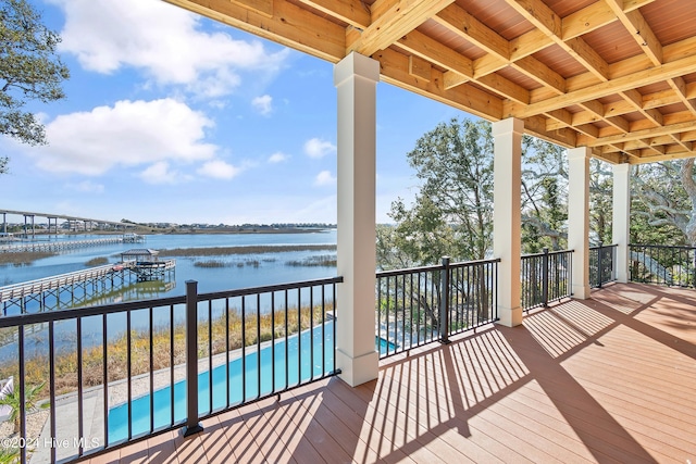 wooden terrace with a water view and a dock