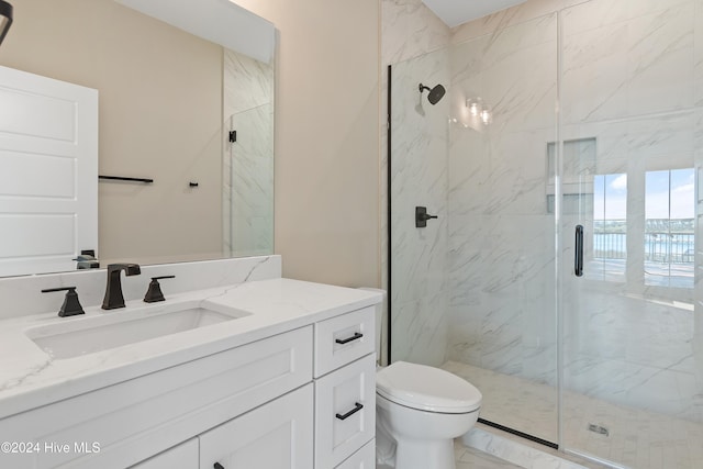 bathroom with vanity, toilet, and an enclosed shower