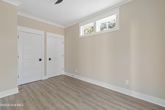 unfurnished bedroom with crown molding, ceiling fan, and light hardwood / wood-style floors