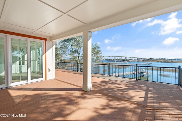 wooden terrace featuring a water view