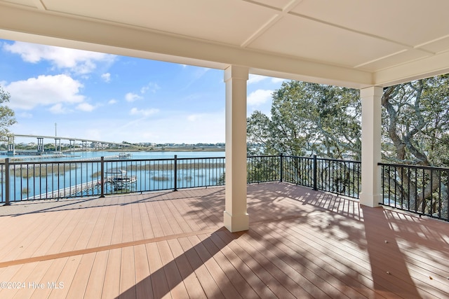 wooden deck with a water view and a dock