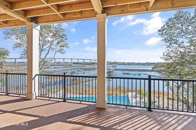 deck with a water view and a pool