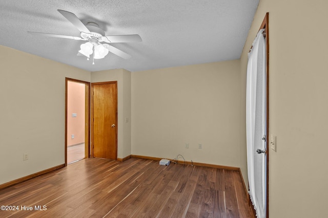 unfurnished bedroom with ceiling fan, wood-type flooring, and a textured ceiling