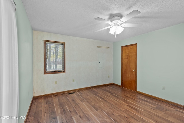 spare room with ceiling fan, a textured ceiling, and hardwood / wood-style flooring