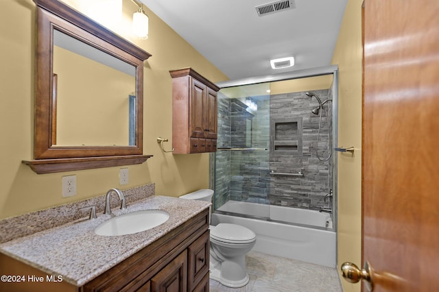 full bathroom featuring vanity, toilet, and bath / shower combo with glass door