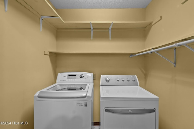 laundry area featuring washer and dryer and a textured ceiling