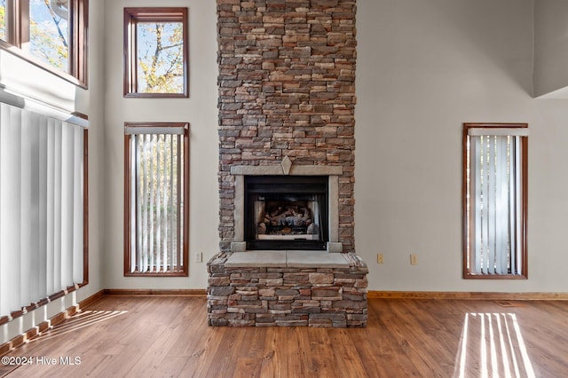 unfurnished living room with hardwood / wood-style flooring and a fireplace