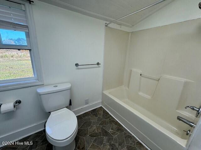 bathroom with toilet, shower / bathtub combination, and lofted ceiling