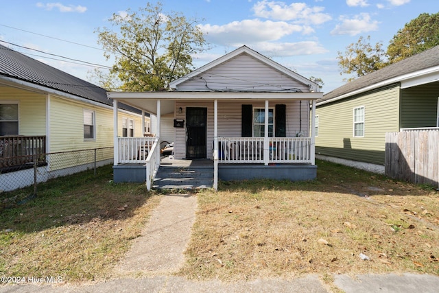 bungalow with a front lawn and a porch