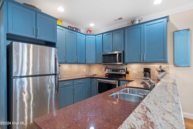 kitchen featuring blue cabinetry and appliances with stainless steel finishes