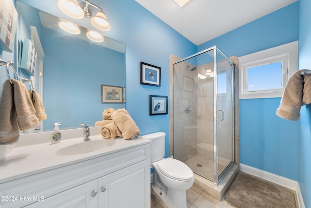 bathroom with tile patterned floors, vanity, toilet, and a shower with door