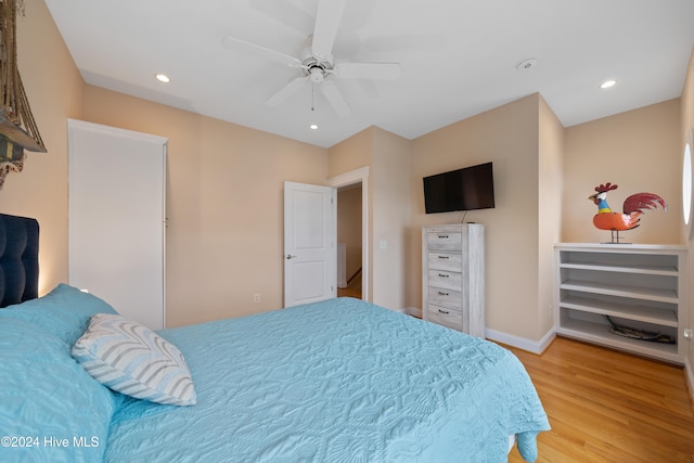 bedroom with wood-type flooring and ceiling fan