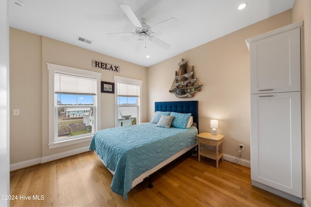 bedroom with ceiling fan and light wood-type flooring