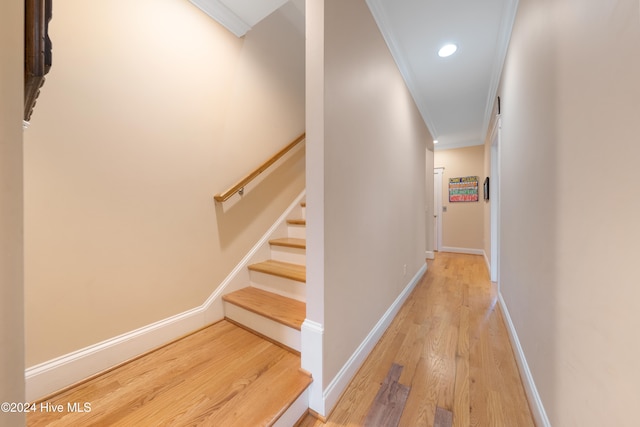 hall featuring light hardwood / wood-style flooring and ornamental molding