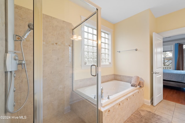 bathroom featuring plus walk in shower and tile patterned floors