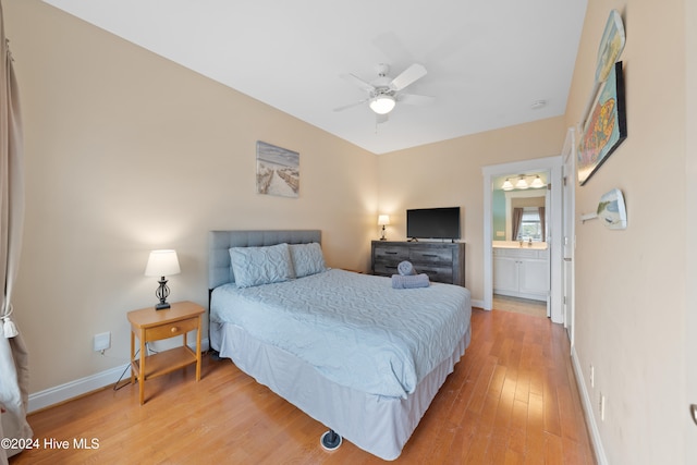 bedroom featuring hardwood / wood-style flooring, ceiling fan, and connected bathroom