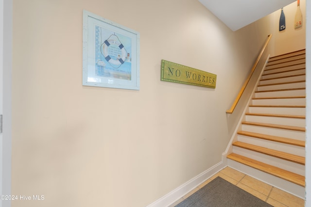 staircase with tile patterned floors