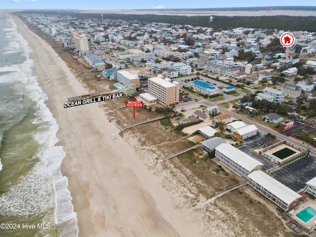 drone / aerial view featuring a water view and a view of the beach