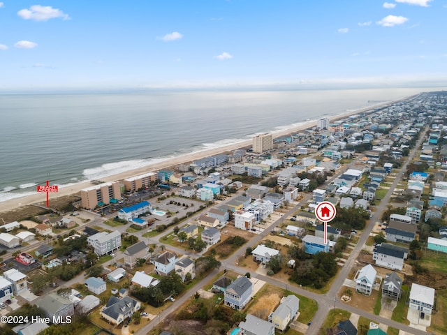 bird's eye view featuring a water view and a beach view