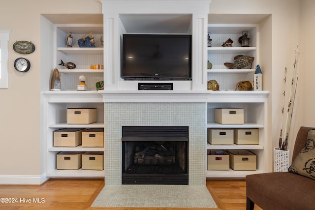 living room with light wood-type flooring and a fireplace