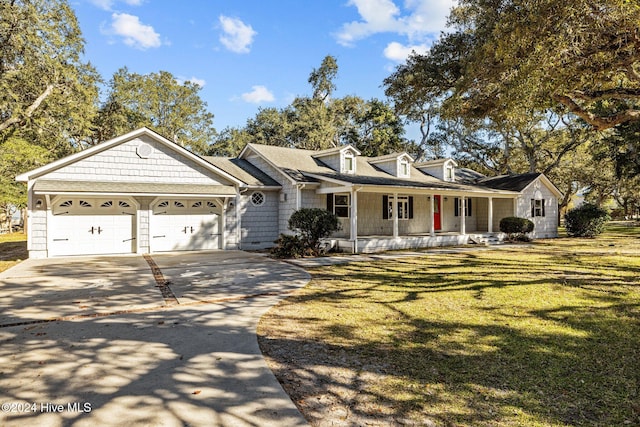 view of front of home with a garage, covered porch, and a front lawn