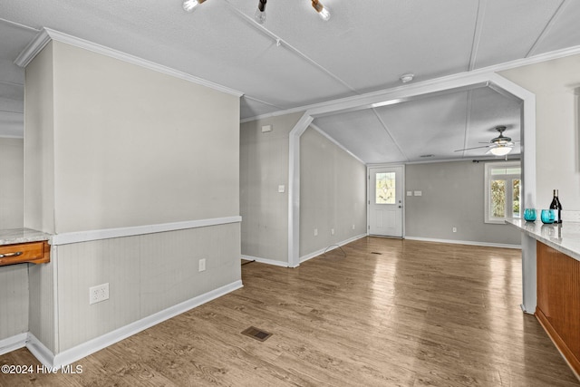 unfurnished living room with ceiling fan, wood-type flooring, a textured ceiling, and lofted ceiling