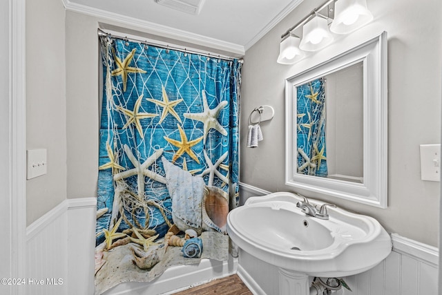 bathroom with sink, hardwood / wood-style floors, and ornamental molding