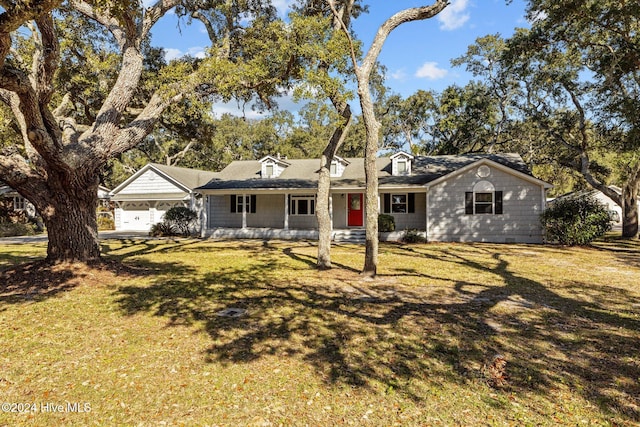 cape cod house with covered porch, a garage, and a front lawn