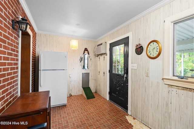 interior space featuring a wall mounted air conditioner, brick wall, crown molding, and wooden walls