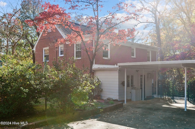 back of property with a carport