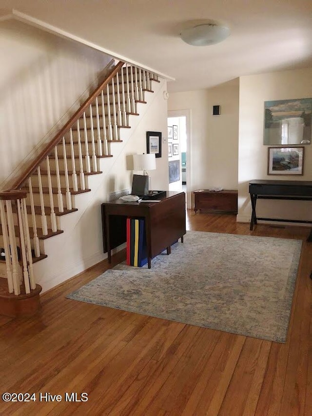 unfurnished living room with radiator heating unit and hardwood / wood-style flooring