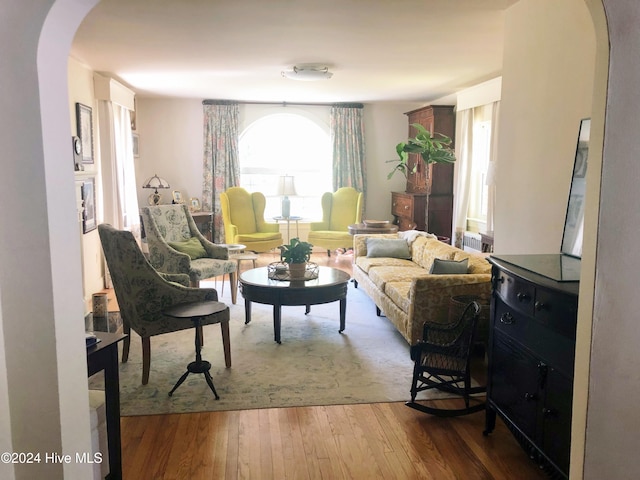 unfurnished dining area with wood-type flooring and an inviting chandelier