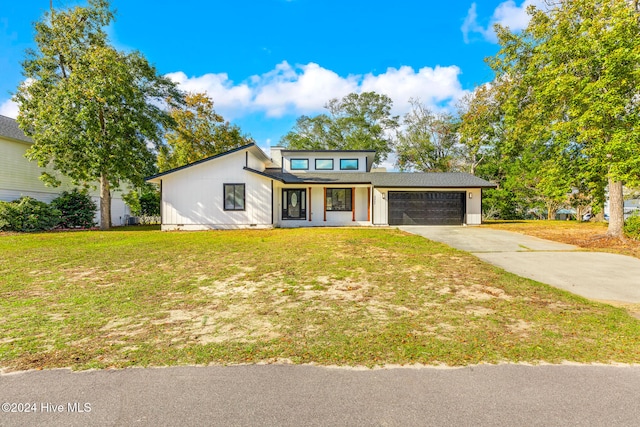 view of front facade featuring a front yard and a garage