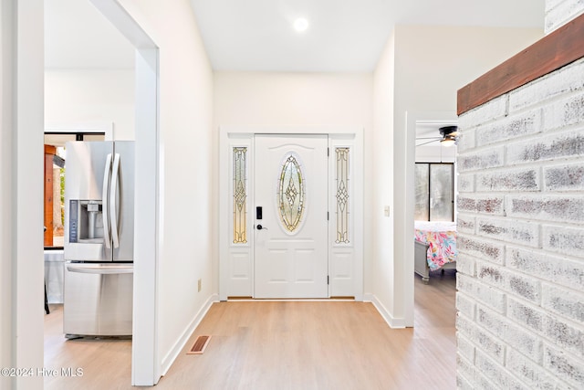 foyer with ceiling fan and light wood-type flooring