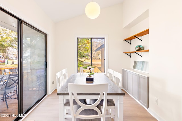 dining room featuring light hardwood / wood-style flooring and lofted ceiling