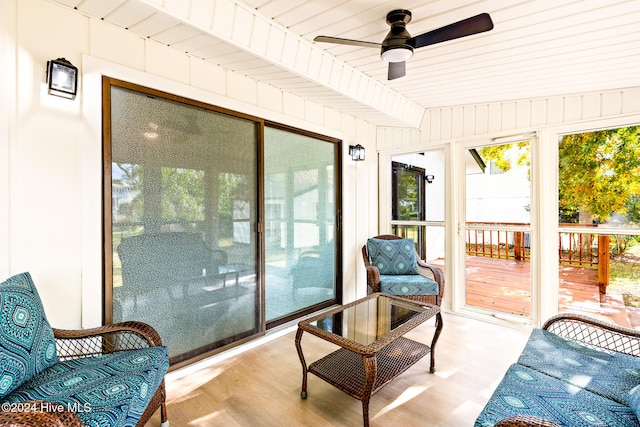 sunroom featuring ceiling fan, beam ceiling, and wood ceiling