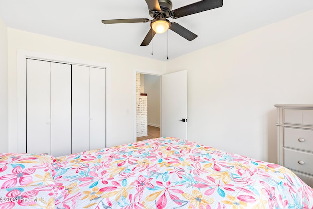 bedroom with wood-type flooring, a closet, and ceiling fan